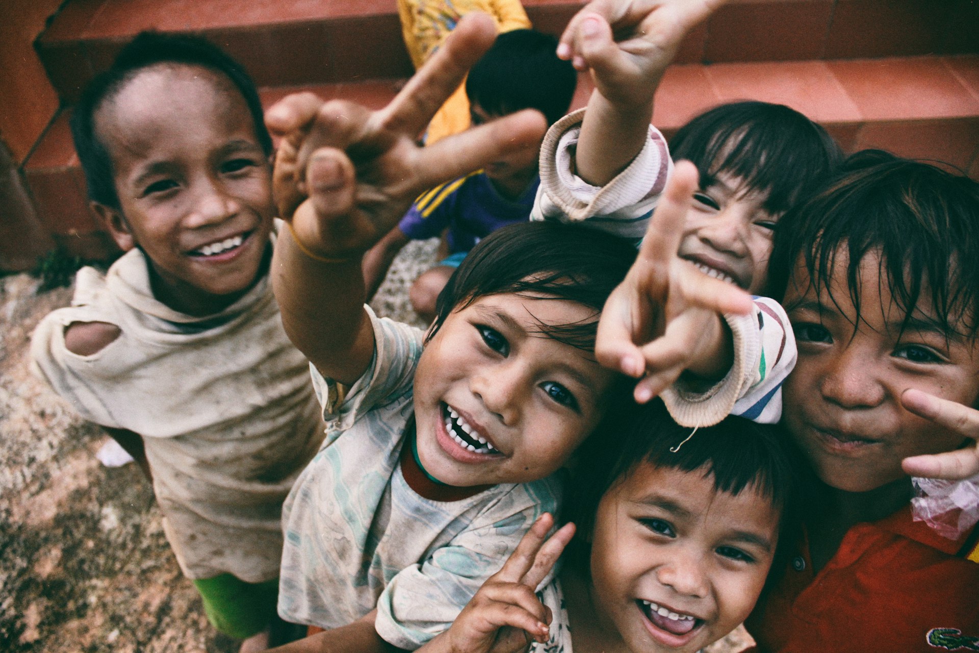 Children with hands raised joyfully in a community moment