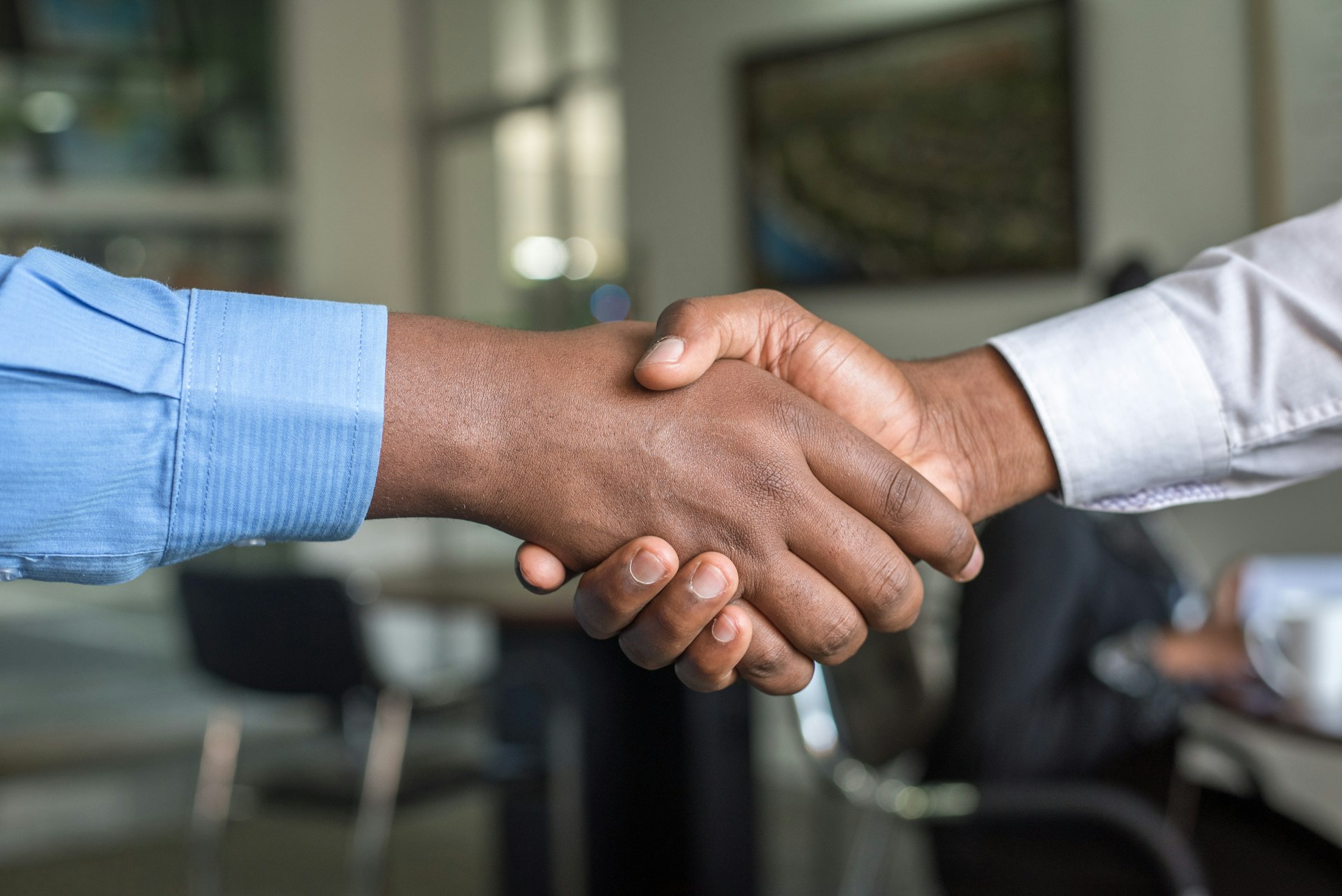 Two pairs of hands meeting in partnership