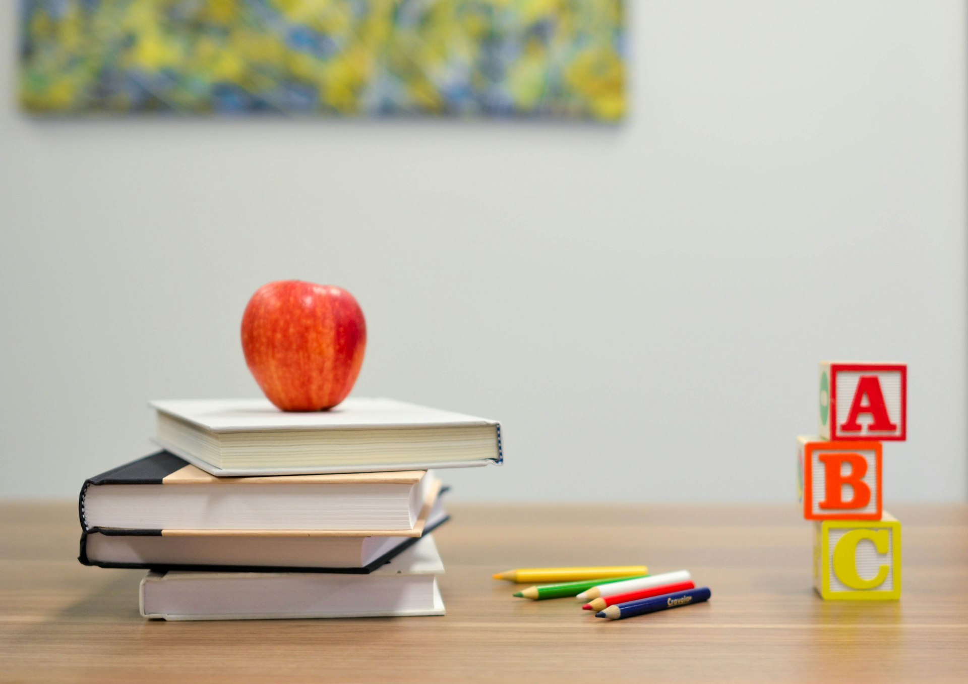 School supplies and books arranged on a wooden desk